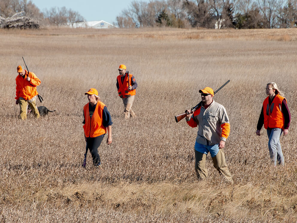 Pheasant hunters in a field - Photo by Travel South Dakota.