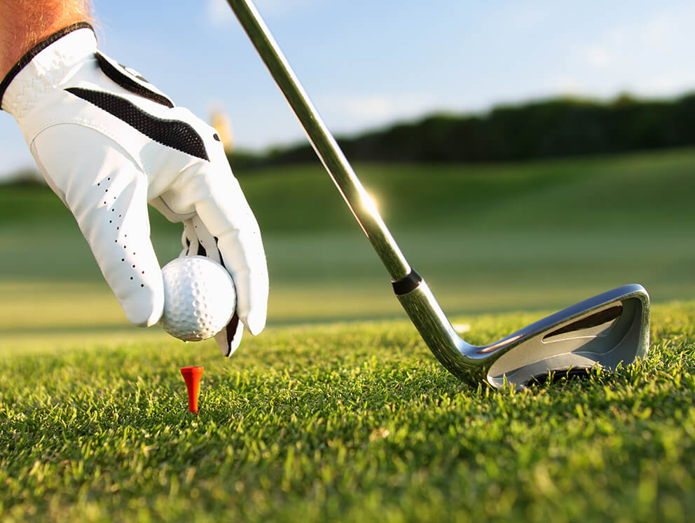 golfer teeing up the ball